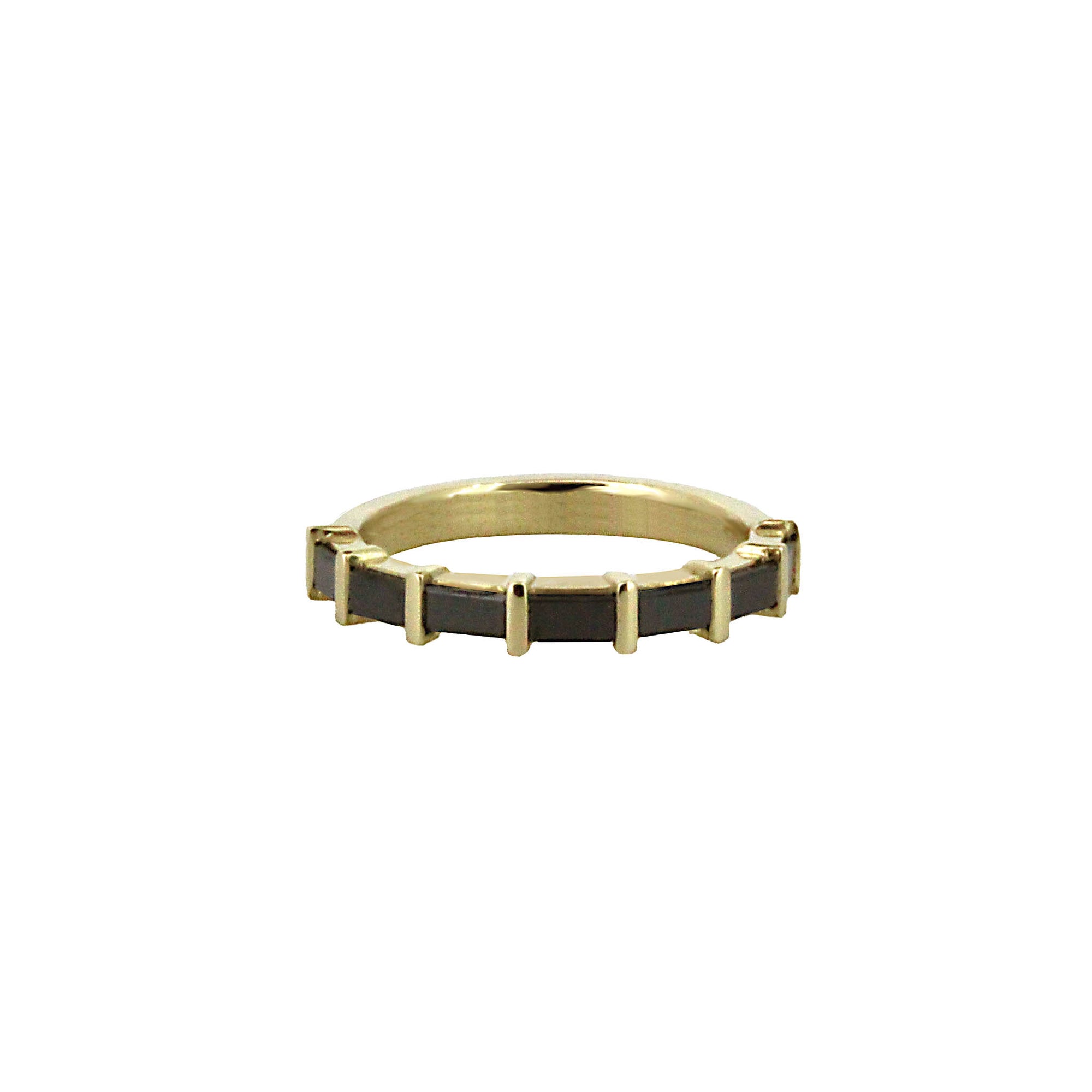 Gold ring with black accents on a white background