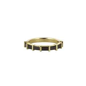Gold ring with black accents on a white background