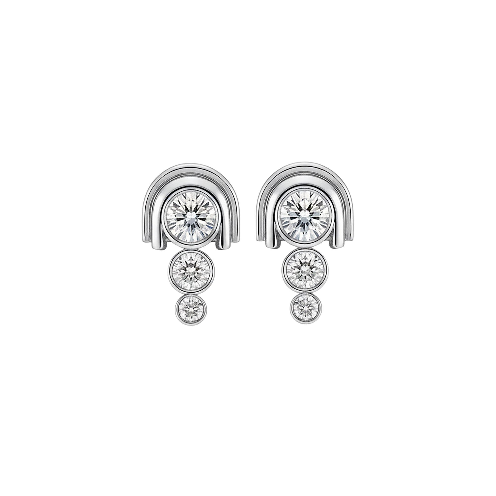 Pair of platinum earrings with diamond-like stones on a white background
