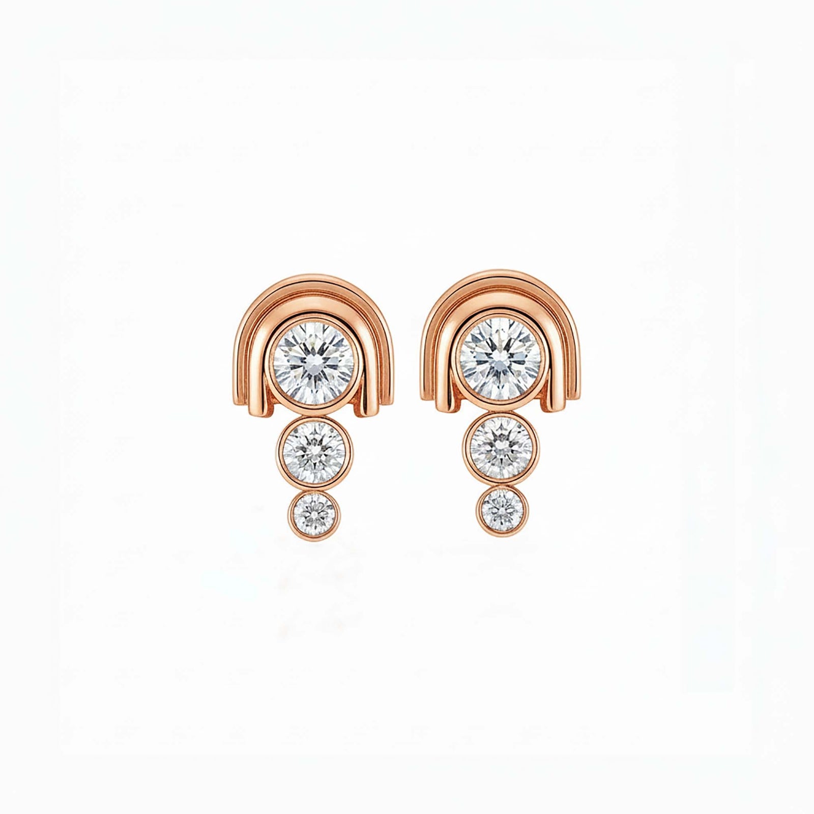 Rose gold earrings with clear gemstones on a white background