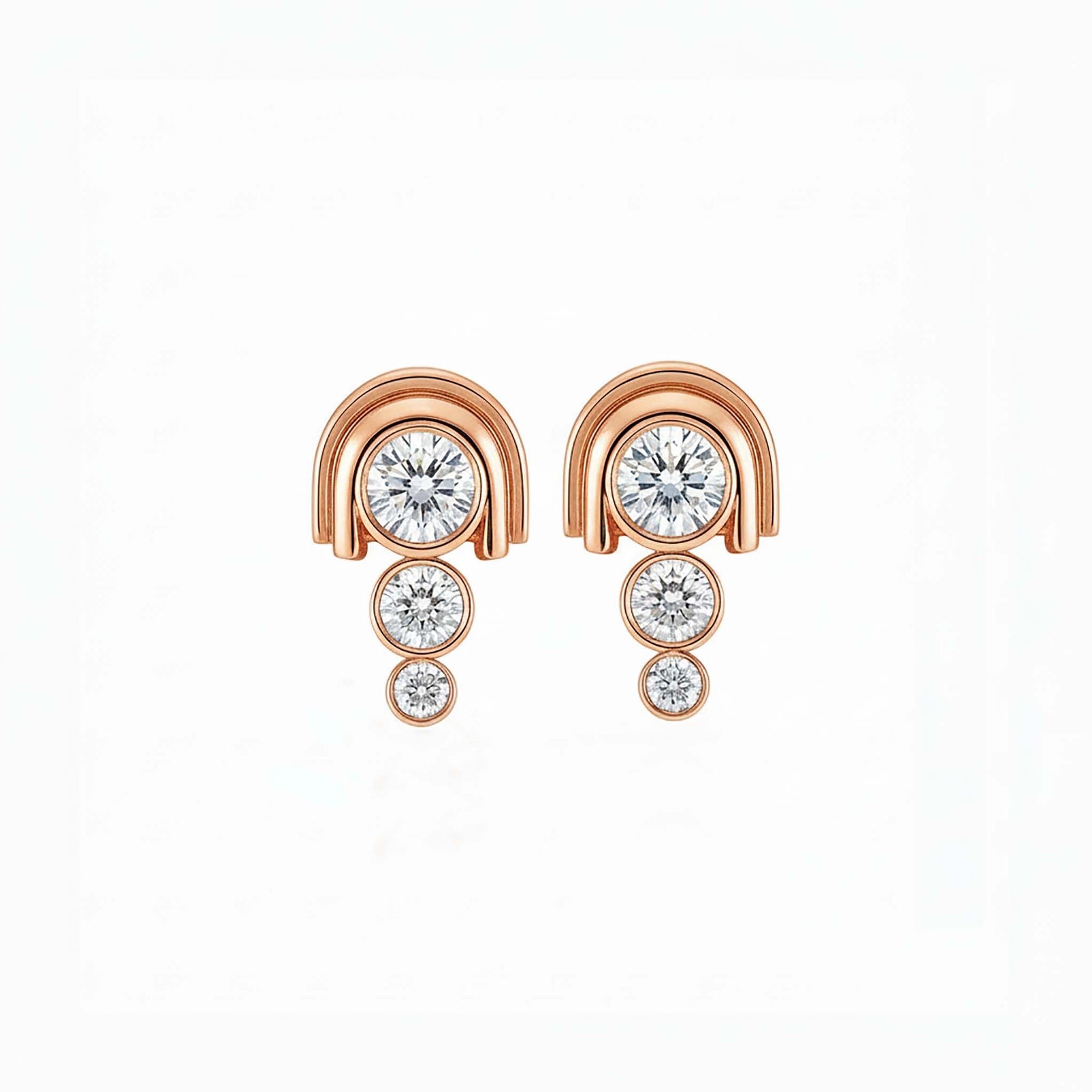 Rose gold earrings with clear gemstones on a white background
