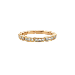 Gold ring with embedded diamonds on a white background