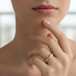 yellow gold ring set with diamonds worn by hand model.
