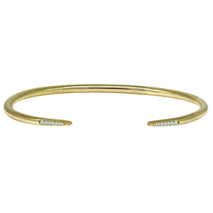 Gold bracelet with small diamonds on a white background