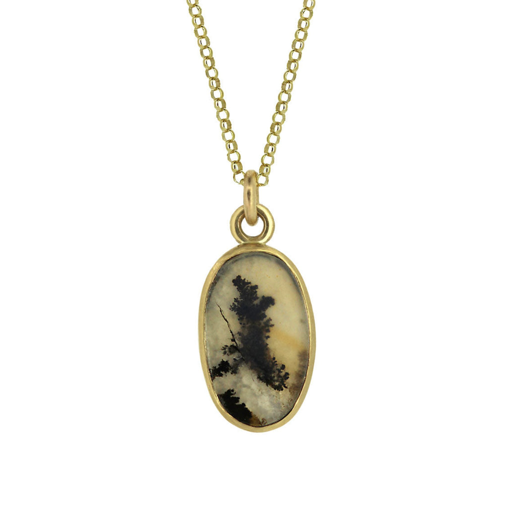 Closeup of dendritic agate set in yellow gold pendant