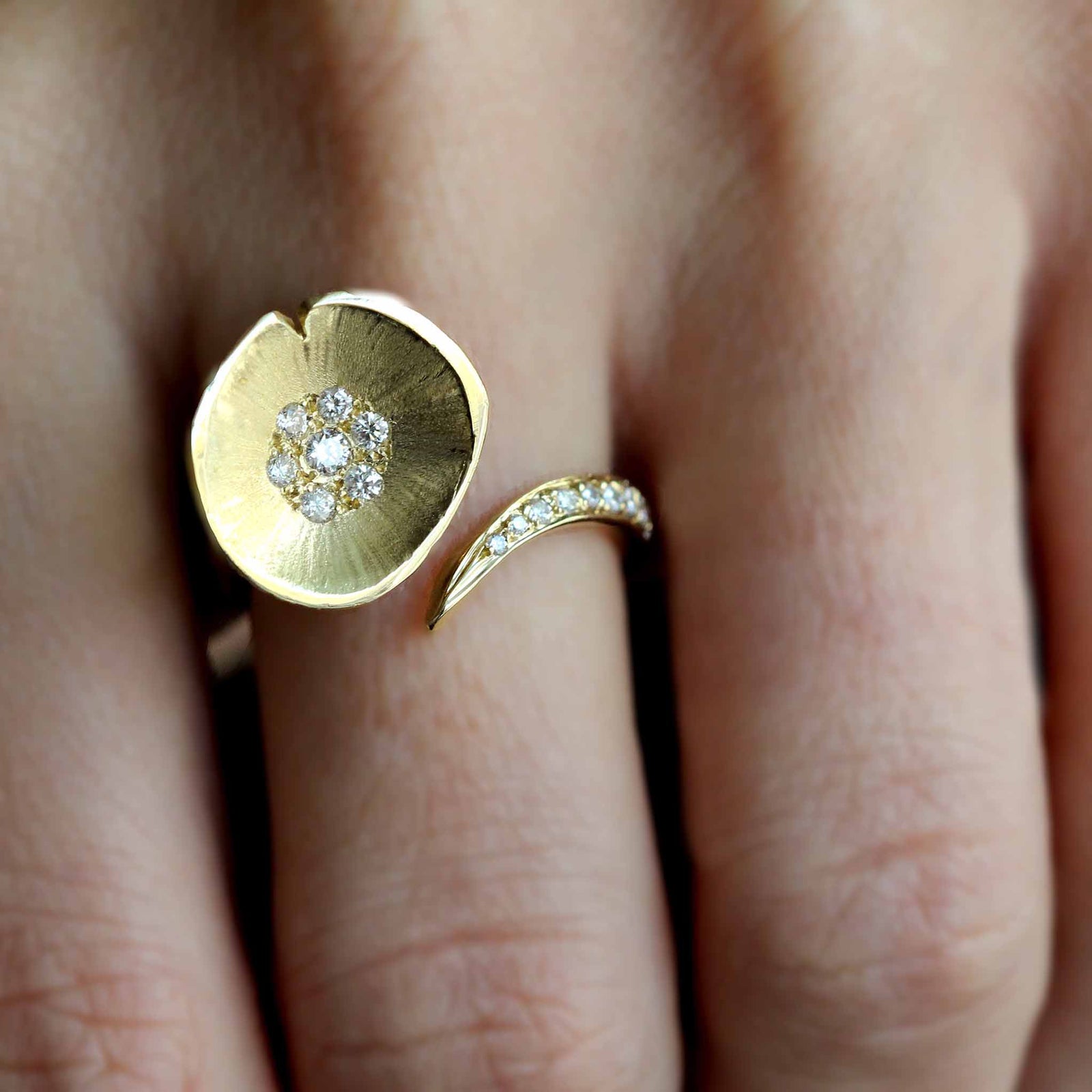 gold and diamond lily pad floating ring has diamond set lilypad on an open band