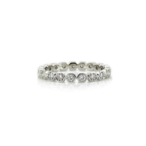 Diamond ring with hexagonal and round stones on a white background