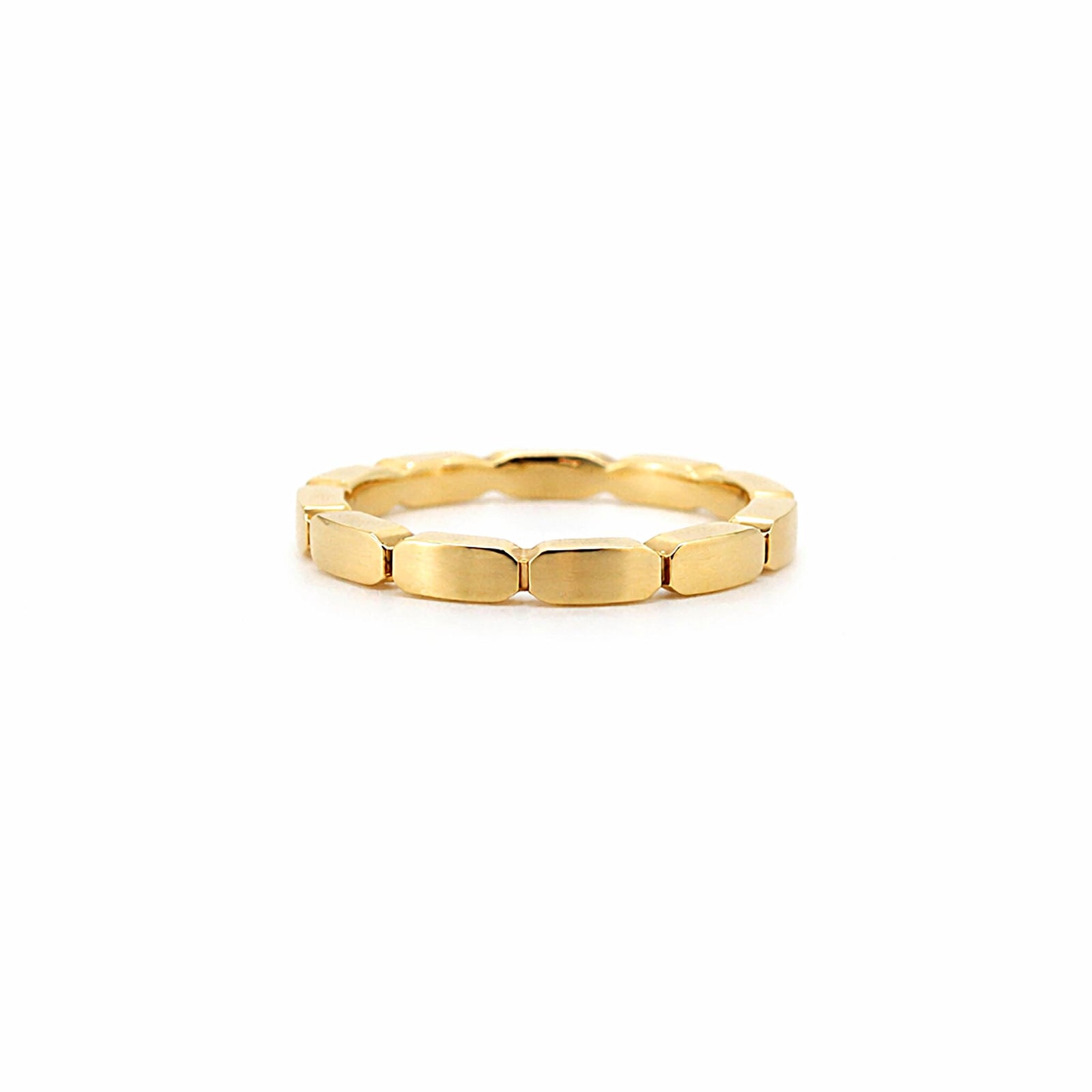 Gold ring with a unique band design on a white background