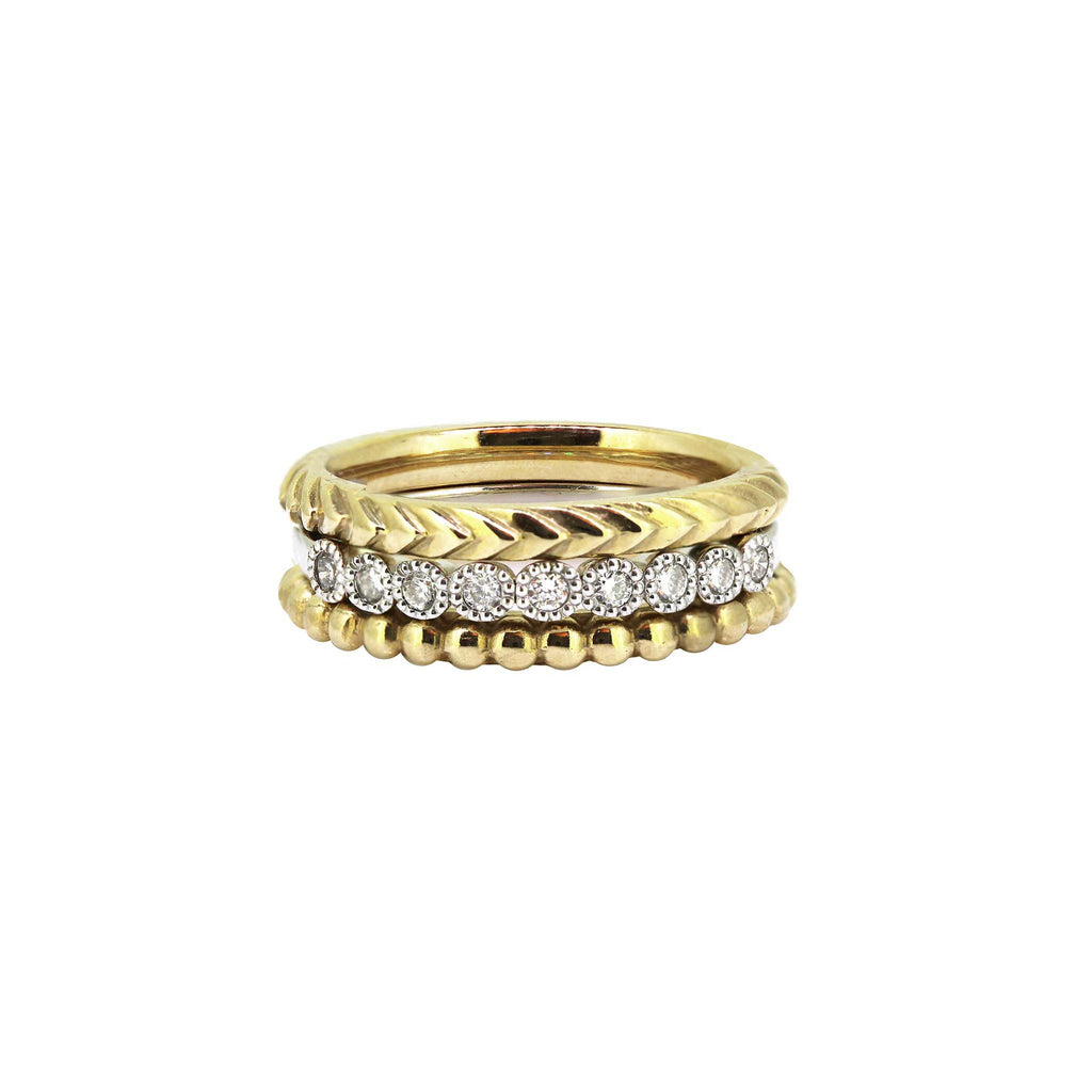 A mix of three stack rings in yellow gold and diamonds