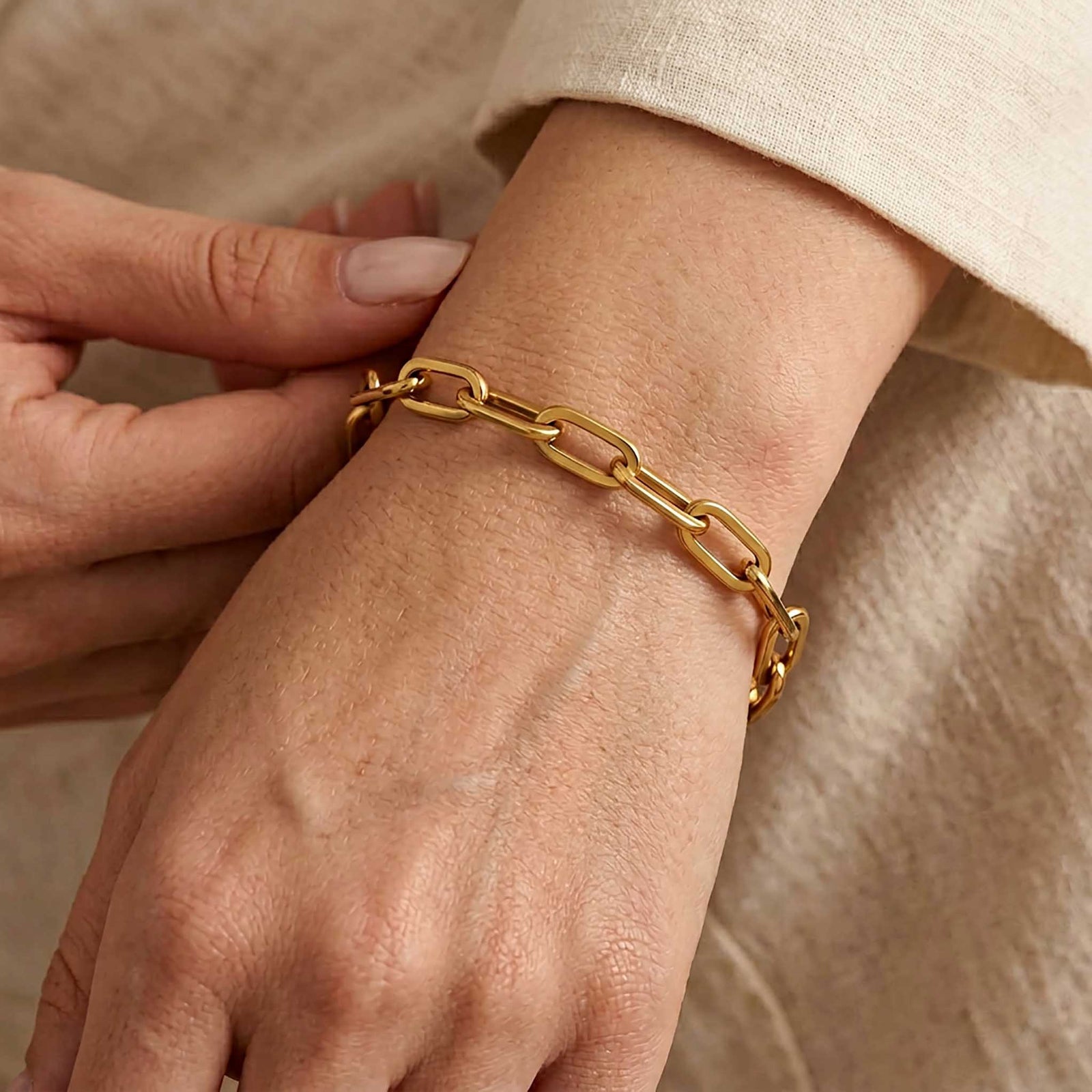 Gold chain bracelet on a white background
