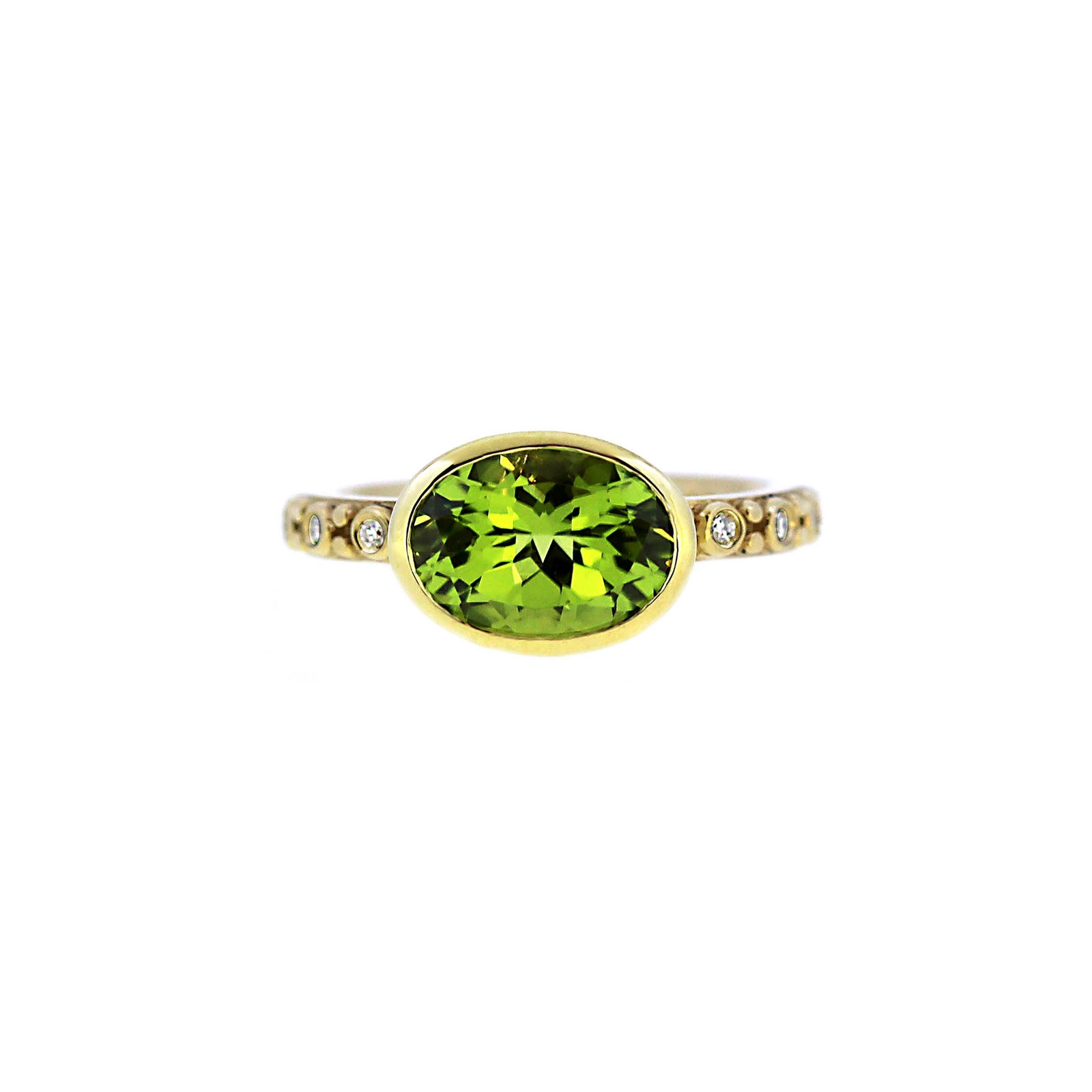 Shimering green oval peridot set in diamond and yellow 14k gold band