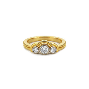 Gold ring with three diamonds on a white background