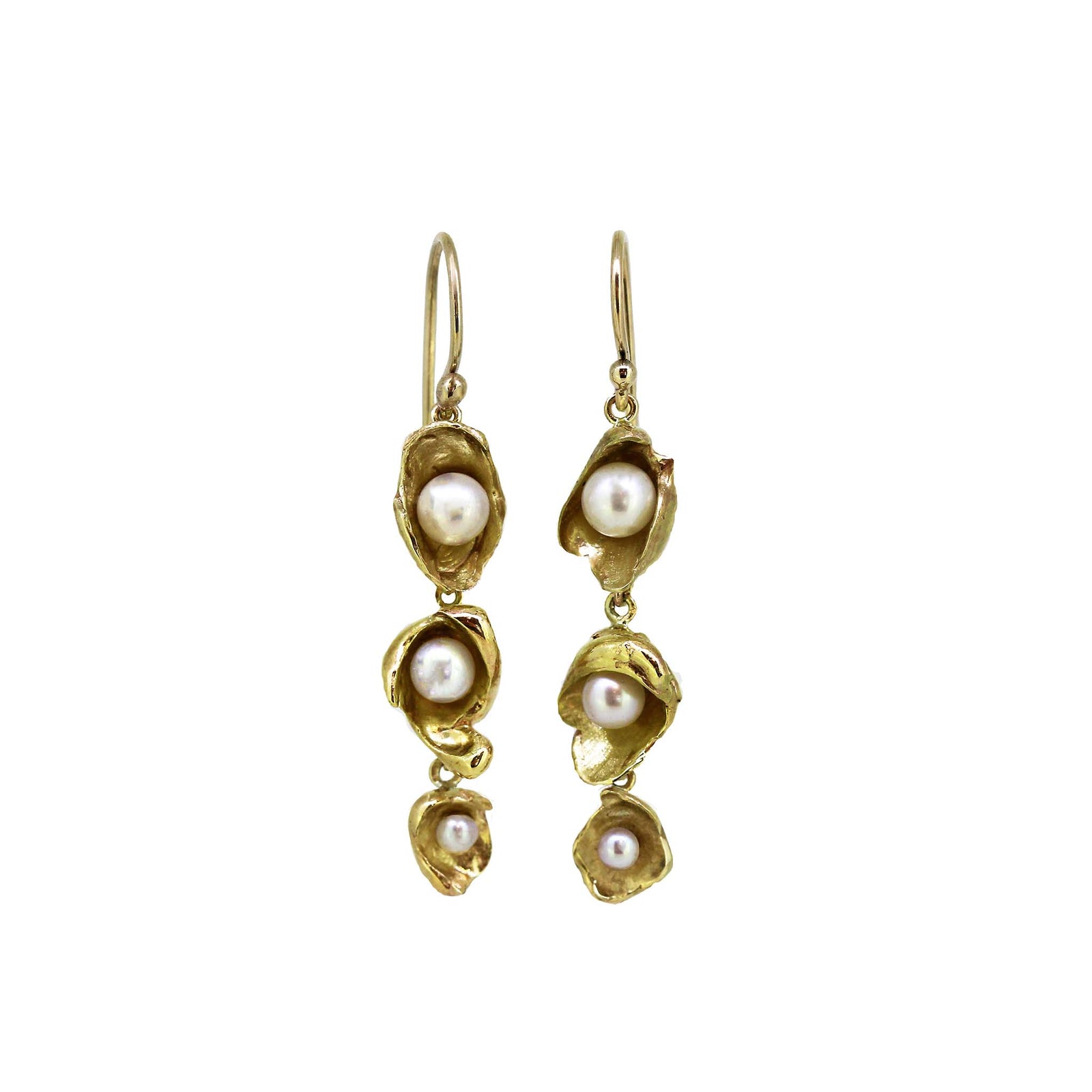 A pair of yellow gold tiered pearl earrings with gold detailing, inspired by sunken ships and treasure chests.