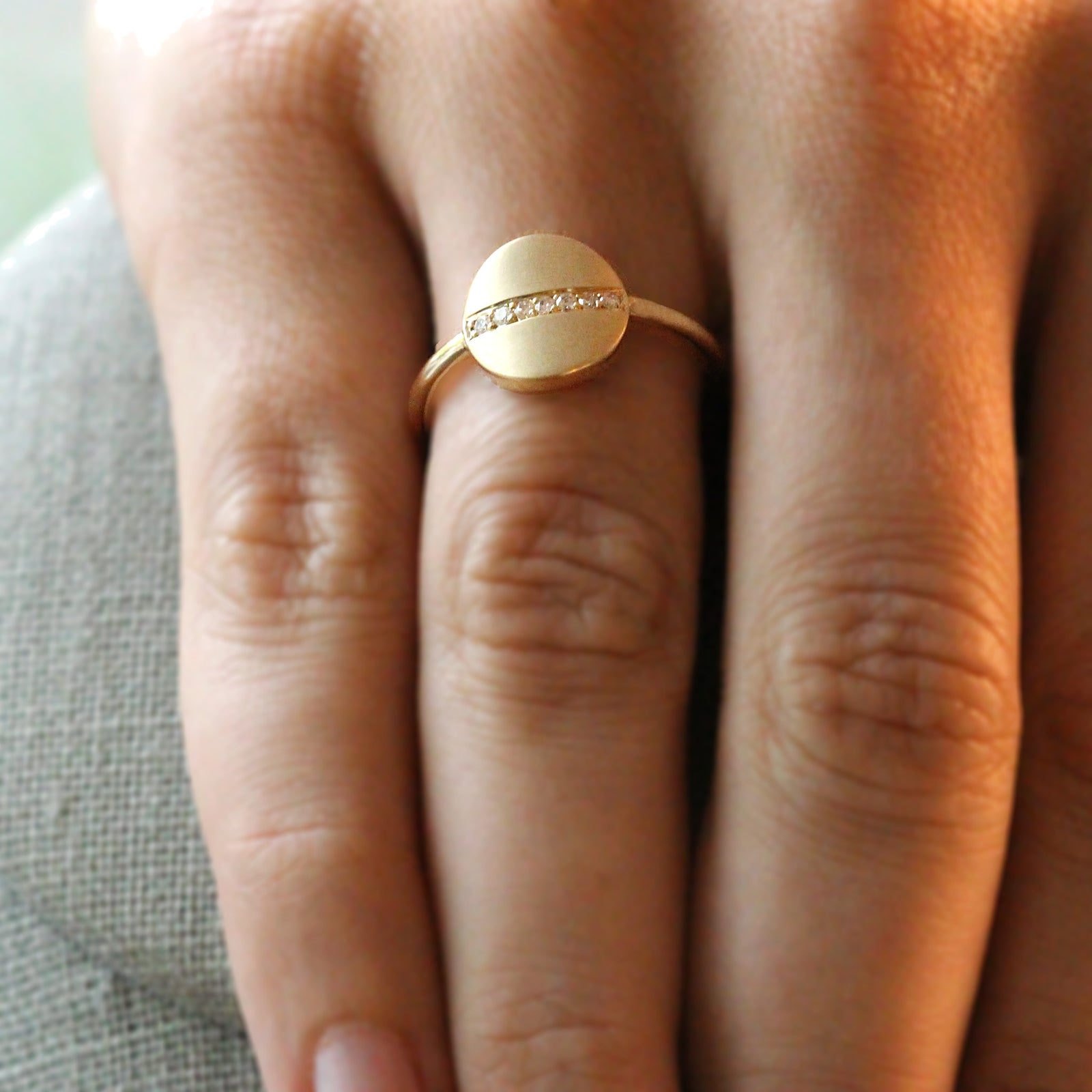 Diamond set cigar ring in yellow gold with a single row of pave diamonds