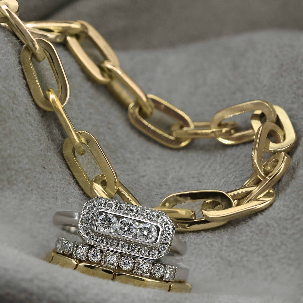 gold paperclip bracelet pictured with diamond rings