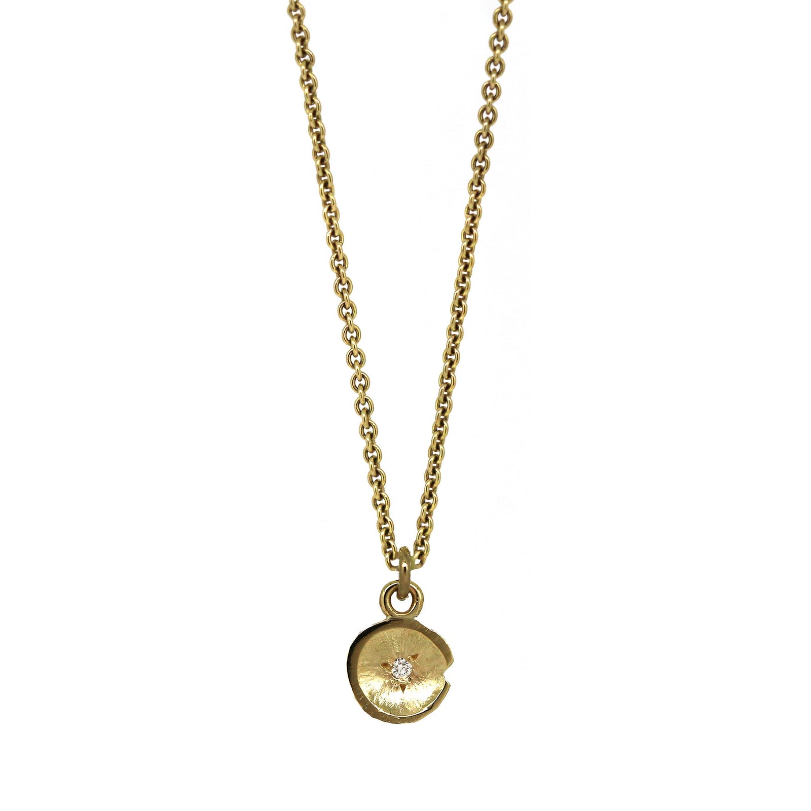 Petit yellow gold Lily Pad pendant with a flush set diamond on a yellow gold chain