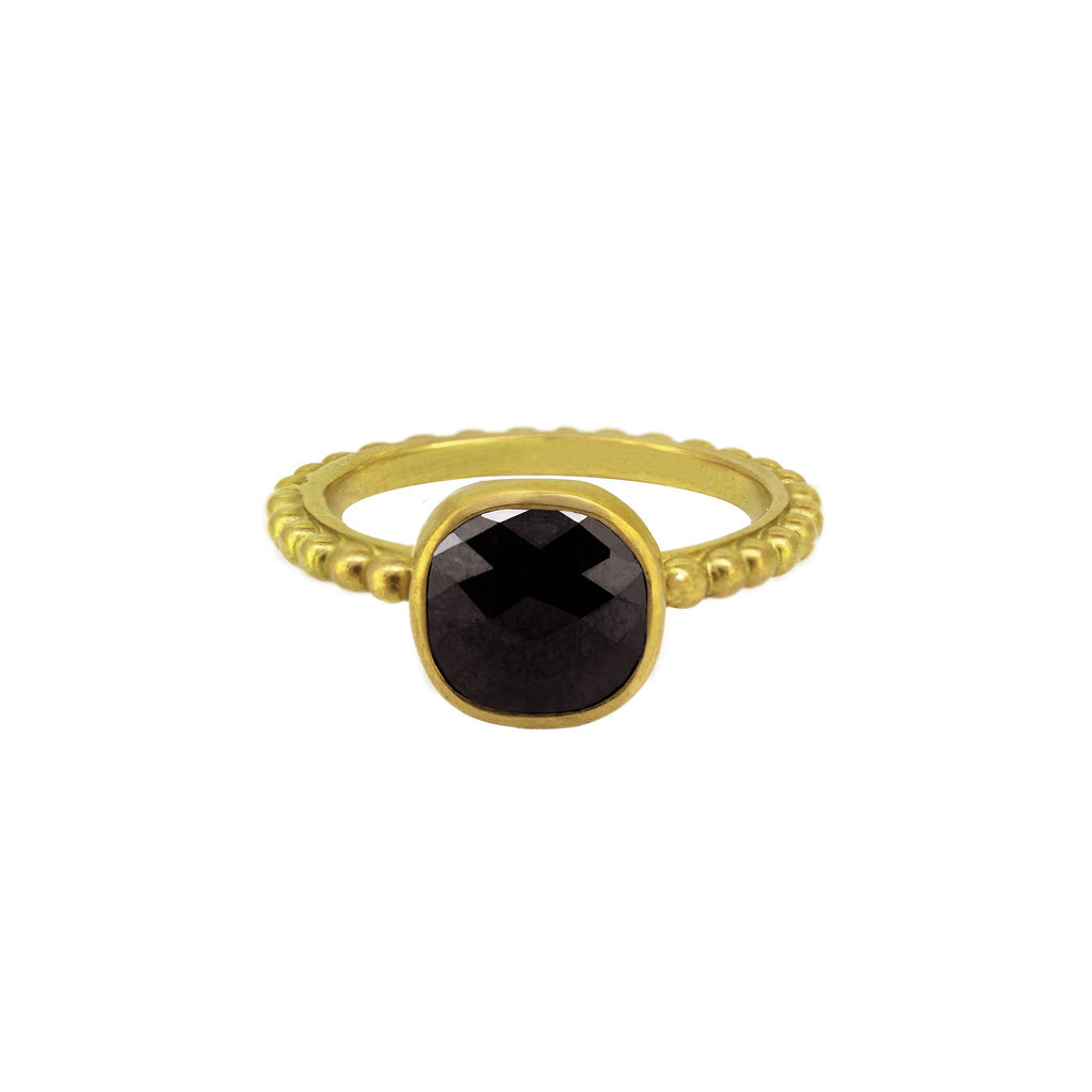 Cabochon cut black diamond stone with checkerboard facets on a Ball band for stacking. yellow gold