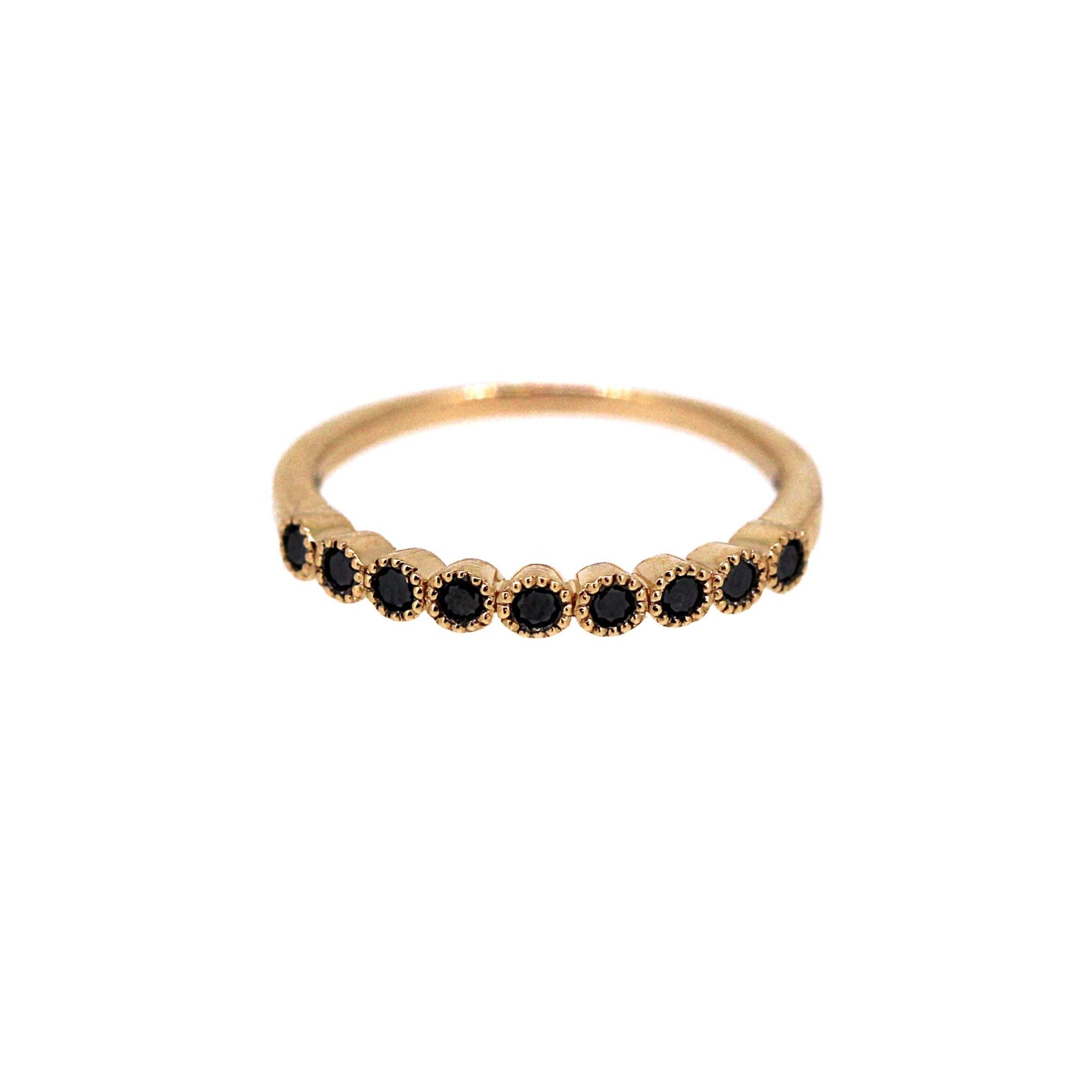 Black diamonds half set on rose gold band with mill grain detail