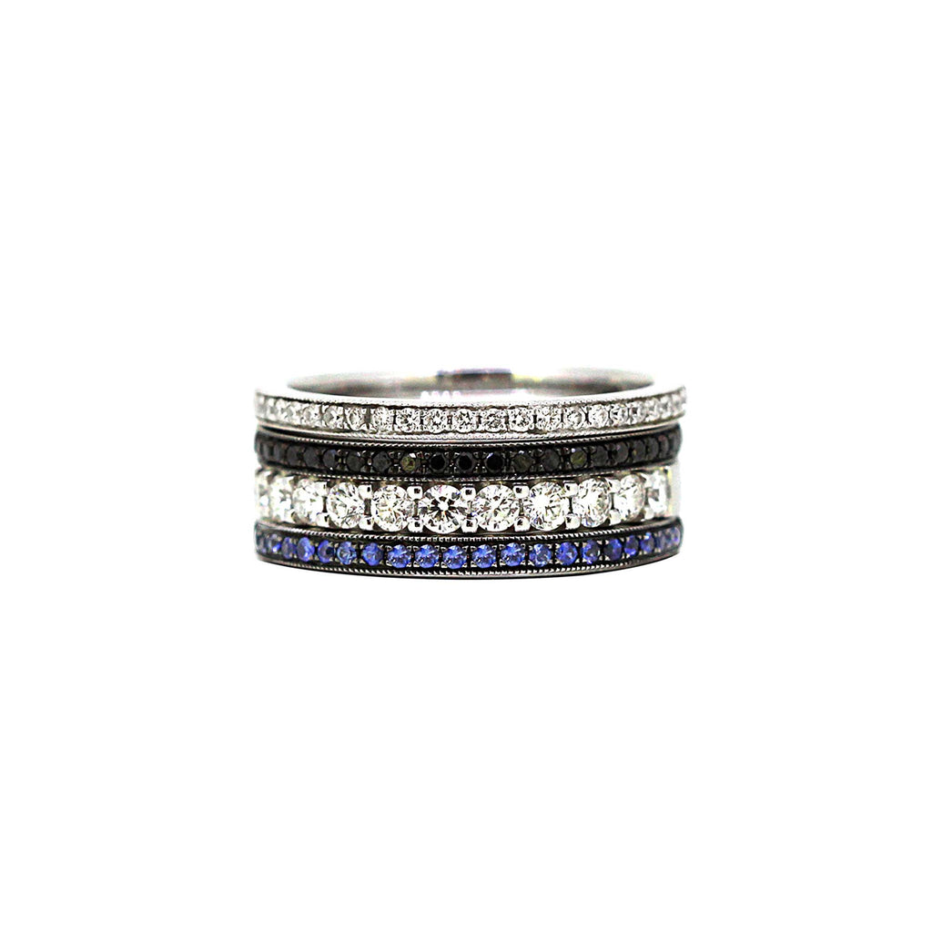 Blue sapphire ring as part of the London Calling stack. Black diamonds, white diamond and sapphires in gold bands